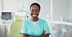 Face, dentist and arms crossed with black woman in scrubs at hospital for dental care or oral hygiene. Portrait, smile for healthcare and happy young orthodontist professional at clinic for dentistry