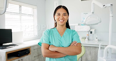 Buy stock photo Face, dentist and arms crossed with asian woman in scrubs at hospital for dental care or oral hygiene. Portrait, smile for medical and happy young orthodontist professional at clinic for dentistry