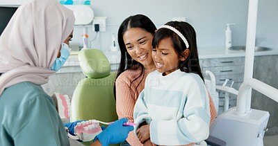 Buy stock photo Child, dentist or education of brushing teeth in office or family friendly demonstration of tooth hygiene. Girl, parent or pediatric orthodontist with dental model to brush or lesson on mouth care