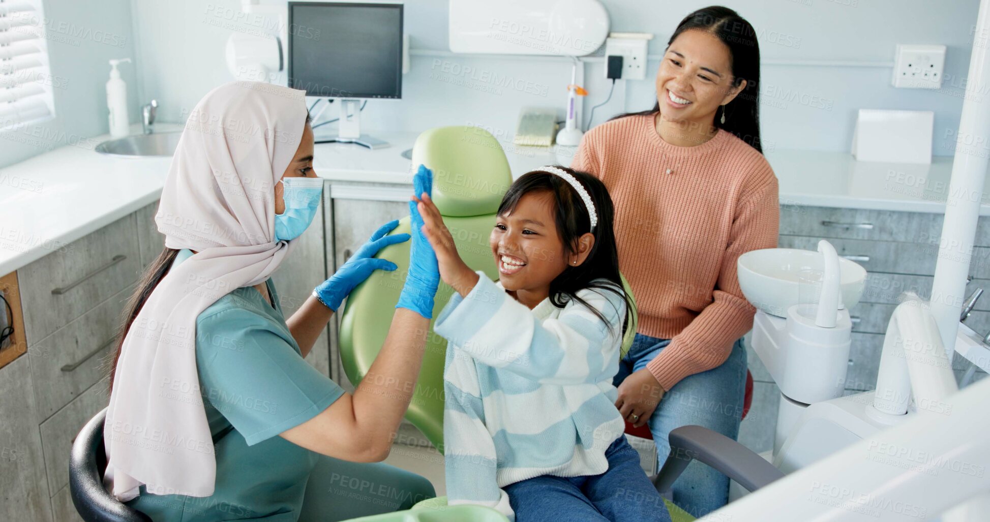 Buy stock photo Kid, dentist and high five for teeth or oral health education for prevention on tooth decay or hygiene. Little girl, mom and together for dentistry checkup or dental examination with orthodontist.