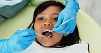 Girl, pediatric dentist and checkup of teeth in chair and family friendly examination for tooth cavities. Child, dental mirror and consultation by orthodontist with trust and exam for caries in mouth