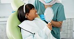 Dentist, woman and kid with mirror for dental health, results and teeth cleaning service with medical advice or support. Orthodontist or doctor talking to child or excited girl of tooth procedure