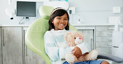 Buy stock photo Face, dentist chair and girl with teddy bear, kid and smile with wellness and oral hygiene. Portrait, person and child with a toy and stuffed animal with checkup and appointment with dental care