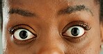 Shock, woman and closeup of face with eyes for strain, optical care and health. Surprise, crazy and zoom portrait of young African female person with omg, wtf or wow facial expression for eyesight.