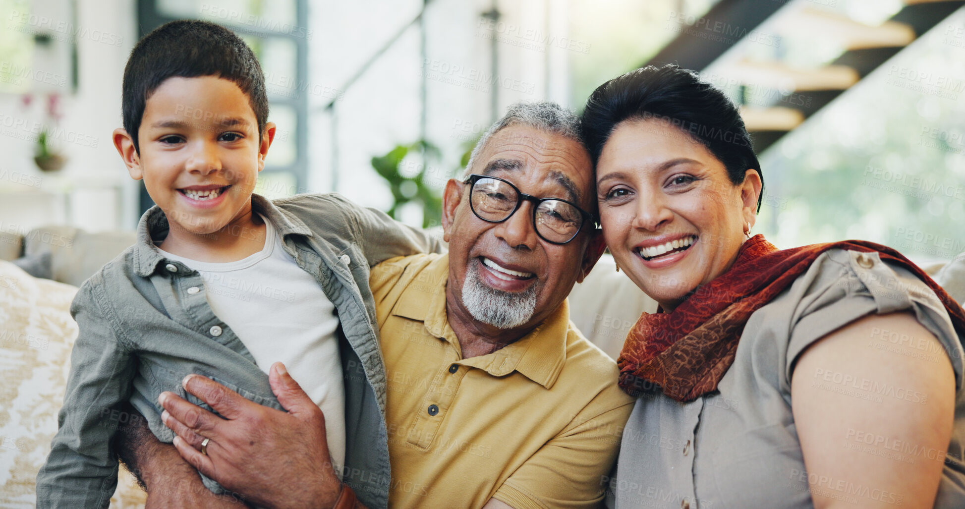 Buy stock photo Portrait, grandparents and child on sofa at house for hug bonding, love and relax with care on weekend break. Woman, man and boy gratitude embrace, family support and security together in lounge
