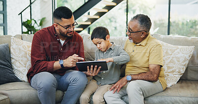 Buy stock photo Tablet, sofa and child with dad and grandfather choose movie, video or film together. Happy, bonding and boy kid watching film on digital technology with father and senior man in living room at home.