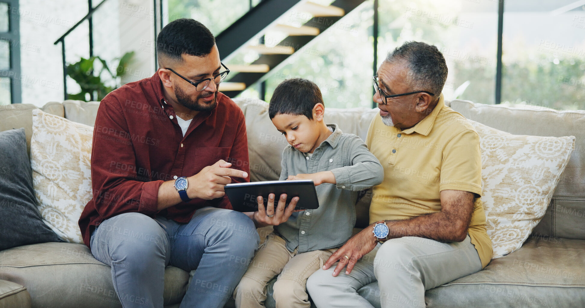 Buy stock photo Tablet, sofa and child with dad and grandfather choose movie, video or film together. Happy, bonding and boy kid watching film on digital technology with father and senior man in living room at home.