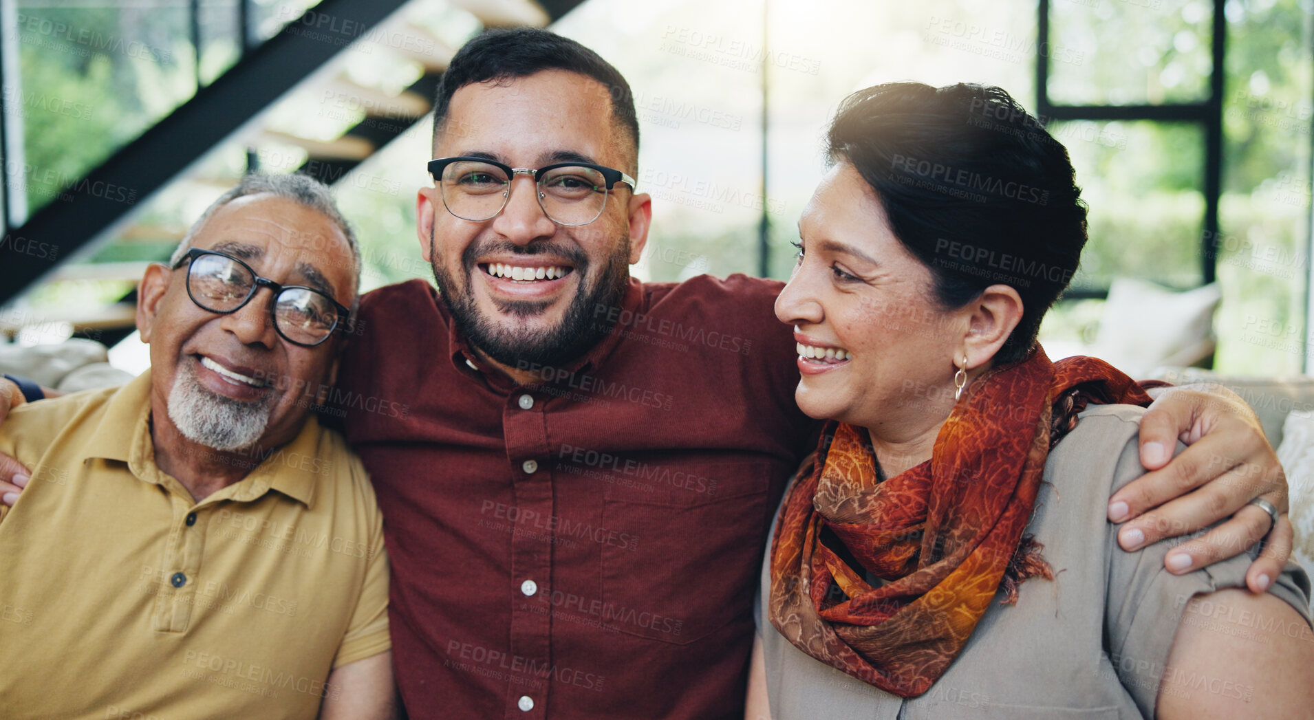 Buy stock photo Smile, man and hug mature parents on sofa at house for bonding, love and relax with care on weekend break. Portrait, family and gratitude or embrace, support and security together in lounge of memory