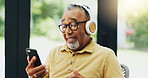 Elderly man, headphones and streaming music on phone, playlist and subscription to radio for audio. Senior person, laptop and reading news on mobile app, podcast and hip hop song for weekend fun