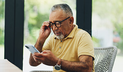 Buy stock photo Glasses, phone and mature man reading news, email or crossword puzzle on internet in home. Smartphone, retirement and blurry vision of person with poor eyesight, glaucoma or squinting on mobile app