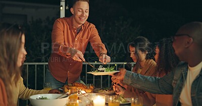 Buy stock photo Friends, night and man with knife for chicken on patio, happy or talk for food at new years eve party. Women, group and cutting at table for chat, memory or giving plate for meat, diversity or event