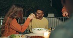 Friends, toast and outdoor dinner on patio, night and conversation with food, new years eve and party. Women, man and group at table with juice, memory or celebration with cheers, diversity and event