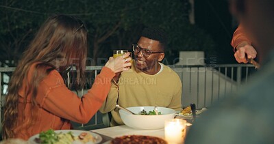 Buy stock photo Friends, toast and outdoor dinner on patio, night and conversation with food, new years eve and party. Women, man and group at table with juice, memory or celebration with cheers, diversity and event