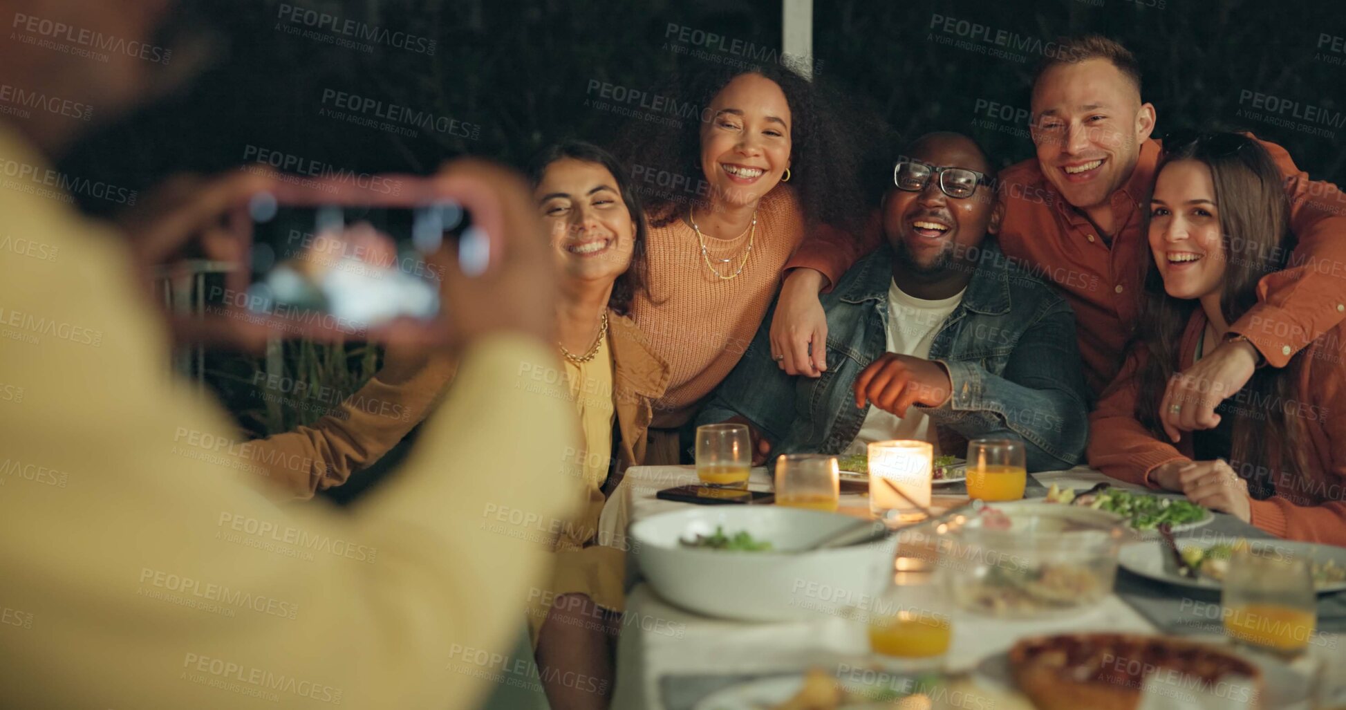 Buy stock photo Friends, photography and outdoor dinner with phone, patio or happy for new years eve celebration on blog. Women, men and group with sign, icon and hug with smartphone screen for post on social media