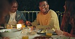 Friends, laughing and dinner at party, patio and happy for conversation, food and new years eve celebration. Woman, men and group at table with joke, memory and night with story, diversity and event