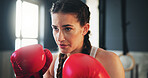 Boxing, woman and fitness in gym for training, self defense and exercise for development. Gloves, power workout and female athlete with equipment for sport, growth and fighting with hard work