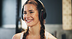 Woman, headphones and smile for training as athlete in fitness center for challenge in sports or wellness. Female person, workout and strong with music, rest for performance in mma, boxing or fight