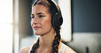 Woman, headphones and music for training as athlete in fitness center for challenge in sports or wellness. Female person, thinking and healthy with ready for performance in mma, boxing match or fight