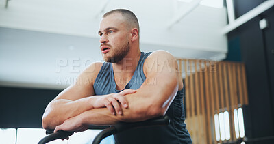 Buy stock photo Fitness, thinking and man on bike in gym, training and workout for cardiovascular with endurance. Health club, cyclist and male athlete on bicycle machine for exercise break, calorie burning or ideas