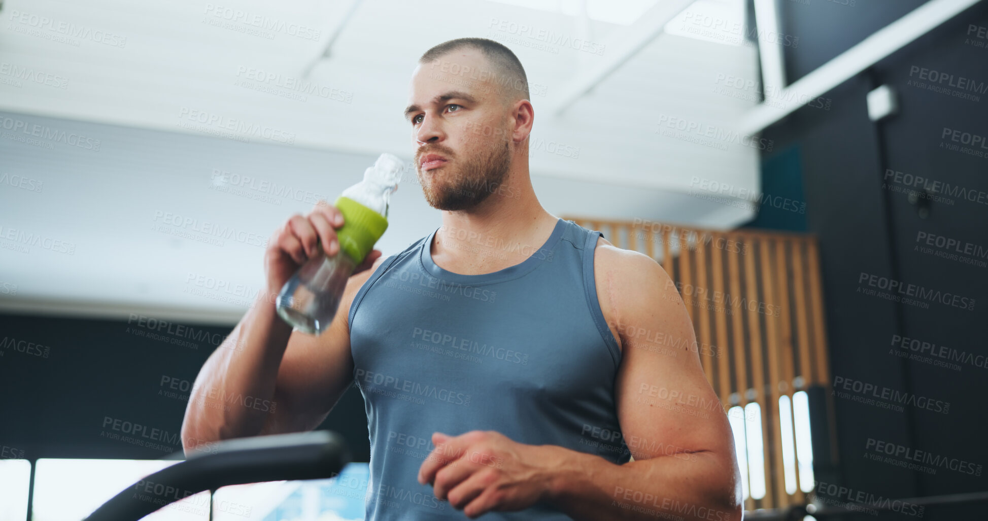 Buy stock photo Fitness, man and drinking water in gym for hydration, thirsty or exercise break of bike machine. Training center, male cyclist and H2O bottle for wellness, healthy diet and think on sports equipment