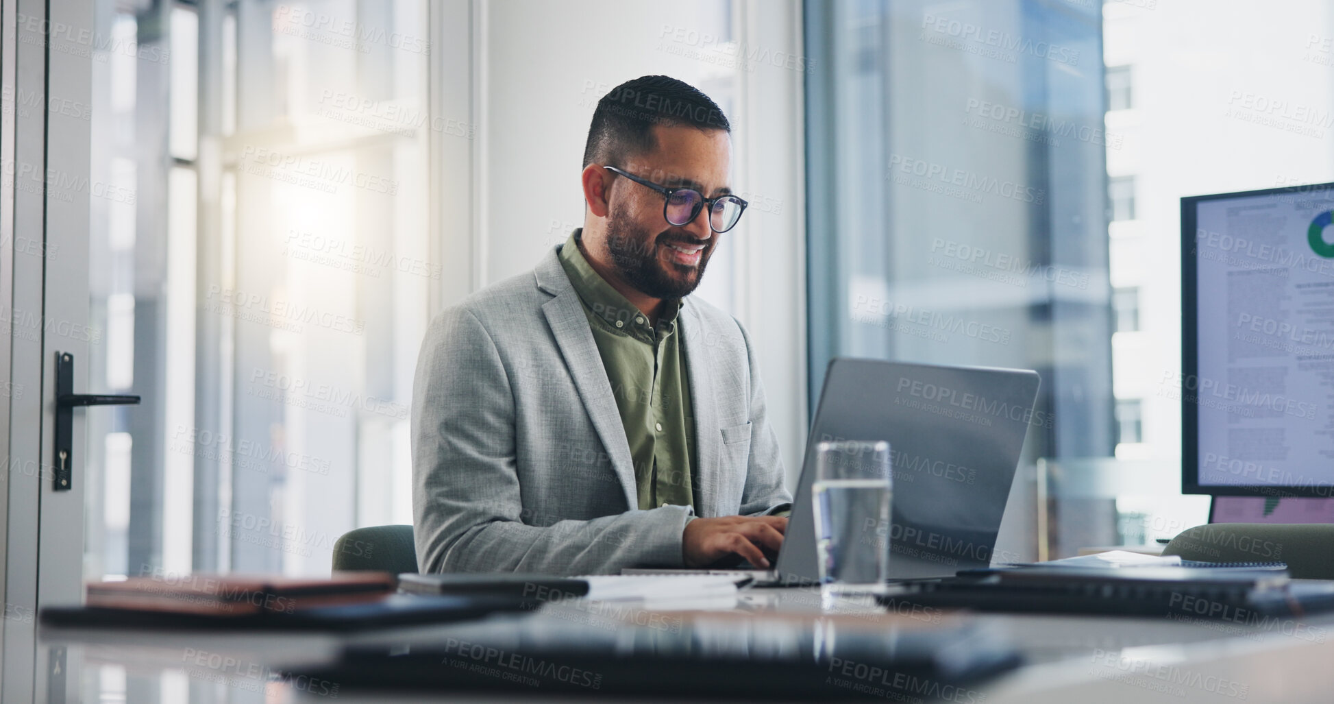 Buy stock photo Businessman, typing and happy with laptop in office for project management feedback and positive website review. Web designer, employee and smile with tech for planning, networking and info update