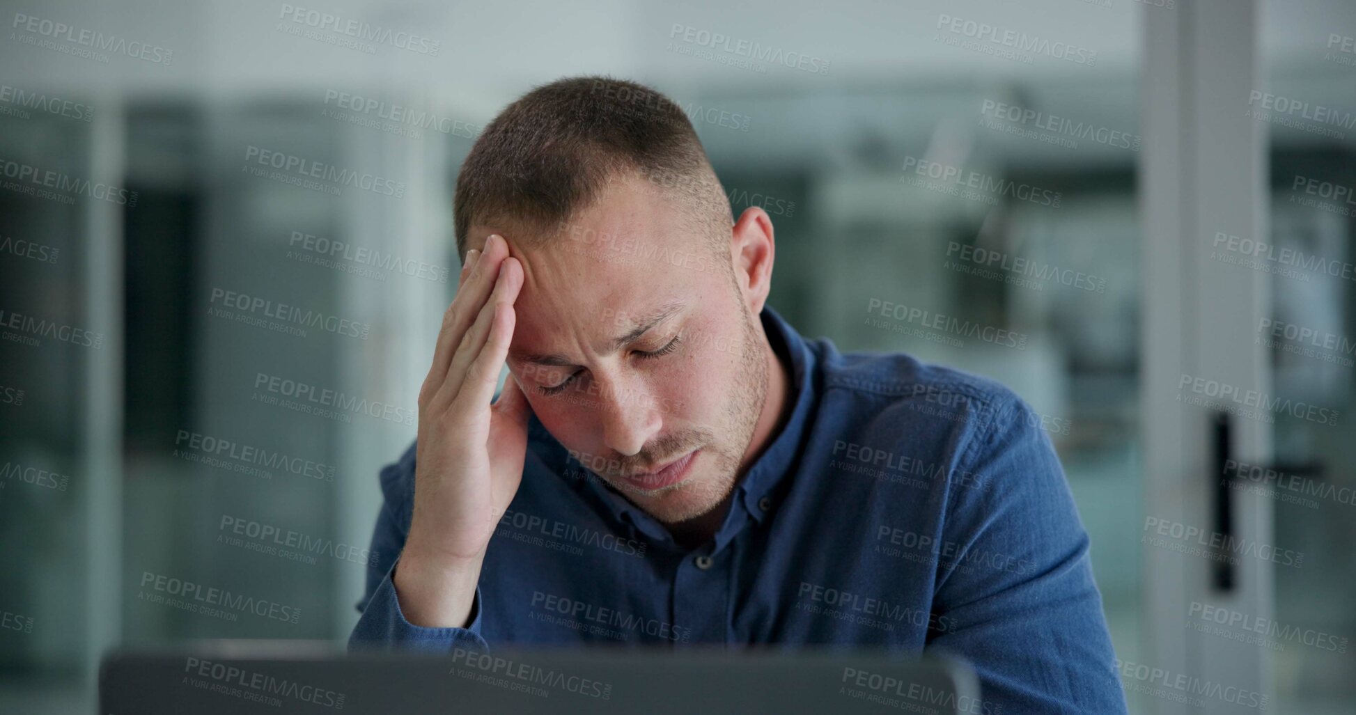 Buy stock photo Laptop, headache and man in office, night and tired of copywriting, hand and burnout for deadline. Computer, editing and employee working late, professional and fatigue with brain fog and project