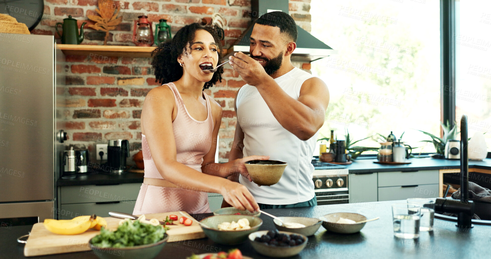 Buy stock photo Happy couple, wellness and tasting in apartment for nutrition, together with spoon for healthy diet. Man, woman and breakfast with fruit in house for morning date, excited for cooking in kitchen