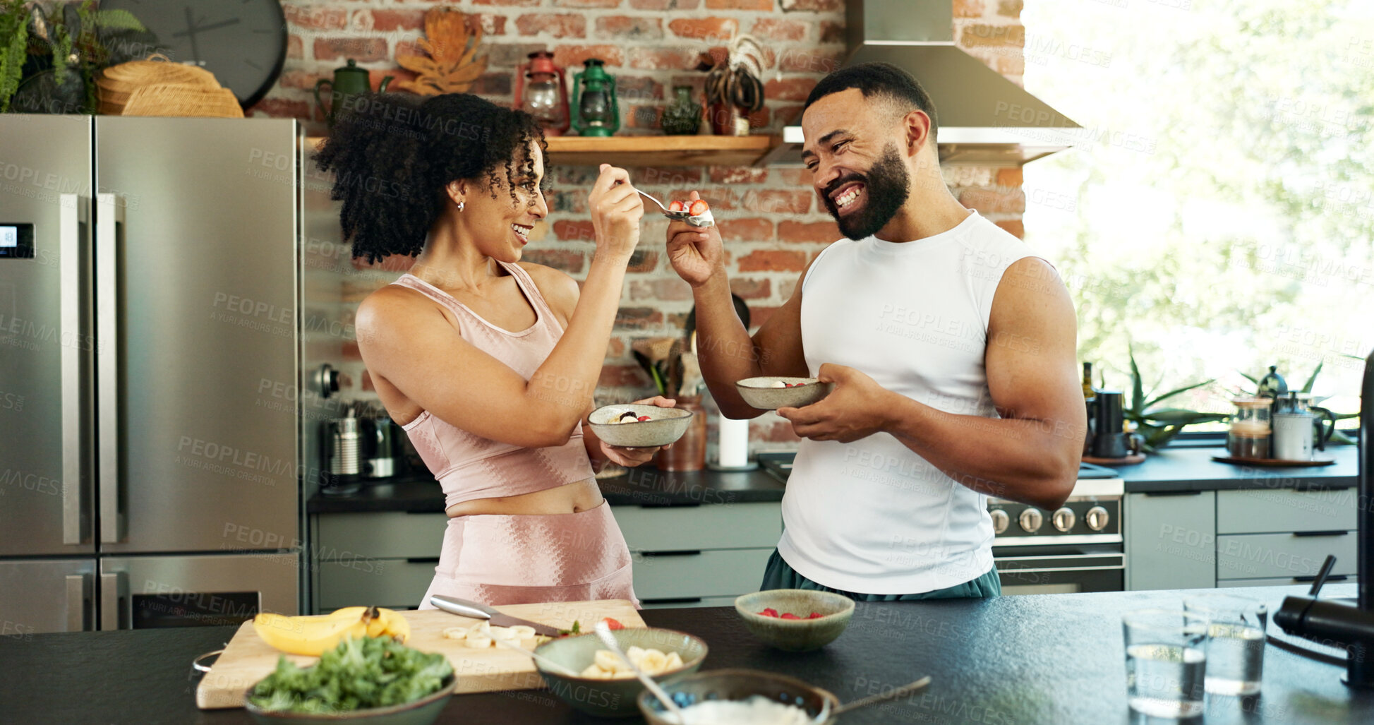 Buy stock photo Home, breakfast and couple with eating in kitchen for healthy diet, nutrition and wellness in morning. Man, woman and smile with fruit in bowl in house for organic, vegan food and love in marriage