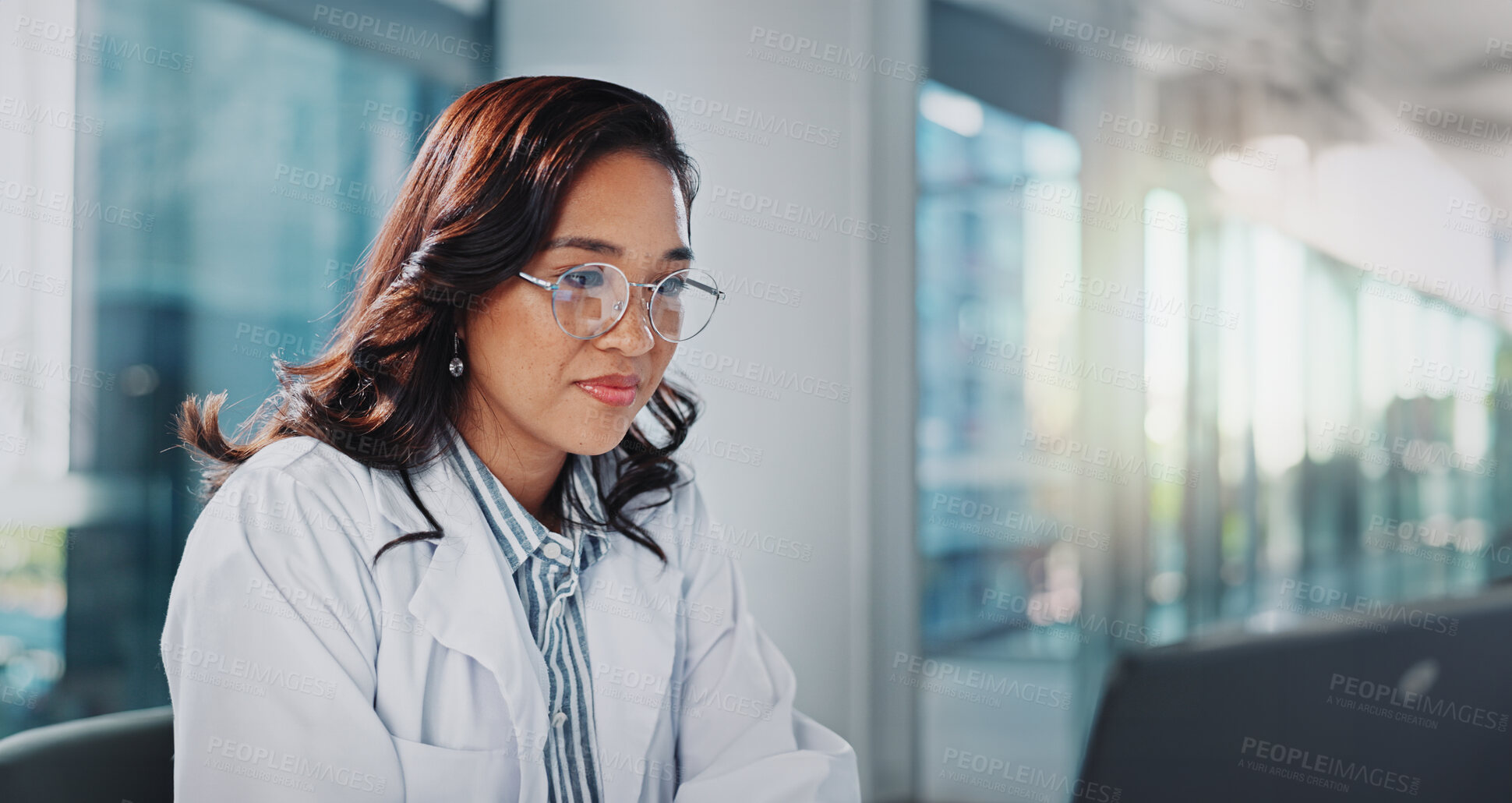 Buy stock photo Woman, doctor and office with reading on laptop for research or study results and feedback. Healthcare, medical and serious with telehealth for medicine, patient information and report at clinic