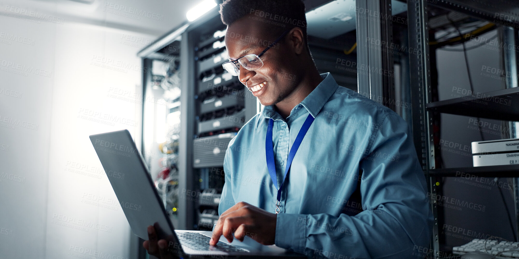 Buy stock photo Laptop, server room and black man on network for database maintenance, programming software or typing. Tech, data center and happy engineer on system for information, cybersecurity or cloud computing