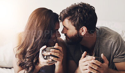 Buy stock photo Happy couple, coffee and relax with love for morning, wake up or breakfast together on bed at home. Young man or woman with smile for bonding, caffeine beverage or drink in bedroom apartment or house