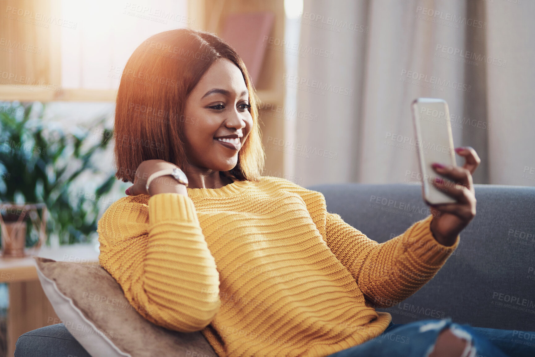 Buy stock photo Happy, smile and black woman on sofa for selfie, social media and communication at home. Female influencer, relax and smiling for photography, status update or networking in living room for followers