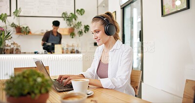 Buy stock photo Laptop, cafe and woman with remote work, writing and headphones for social media blog post. Typing, music and website update of a web designer working at a restaurant and coffee shop with drink