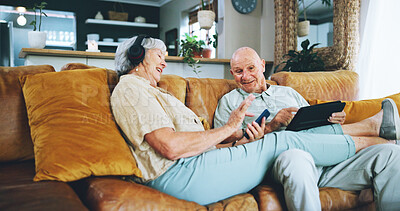 Buy stock photo Senior couple, phone and texting on couch with tablet, choice or click for video, download or search in home. Elderly woman, man and smartphone on lounge sofa with discussion for chat on social media