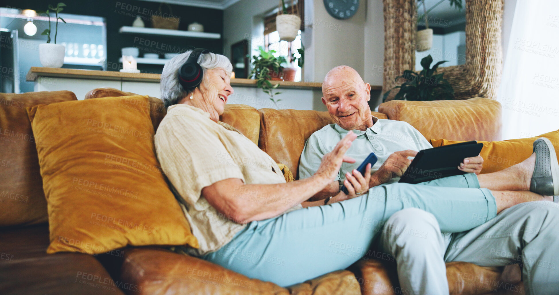 Buy stock photo Senior couple, phone and texting on couch with tablet, choice or click for video, download or search in home. Elderly woman, man and smartphone on lounge sofa with discussion for chat on social media