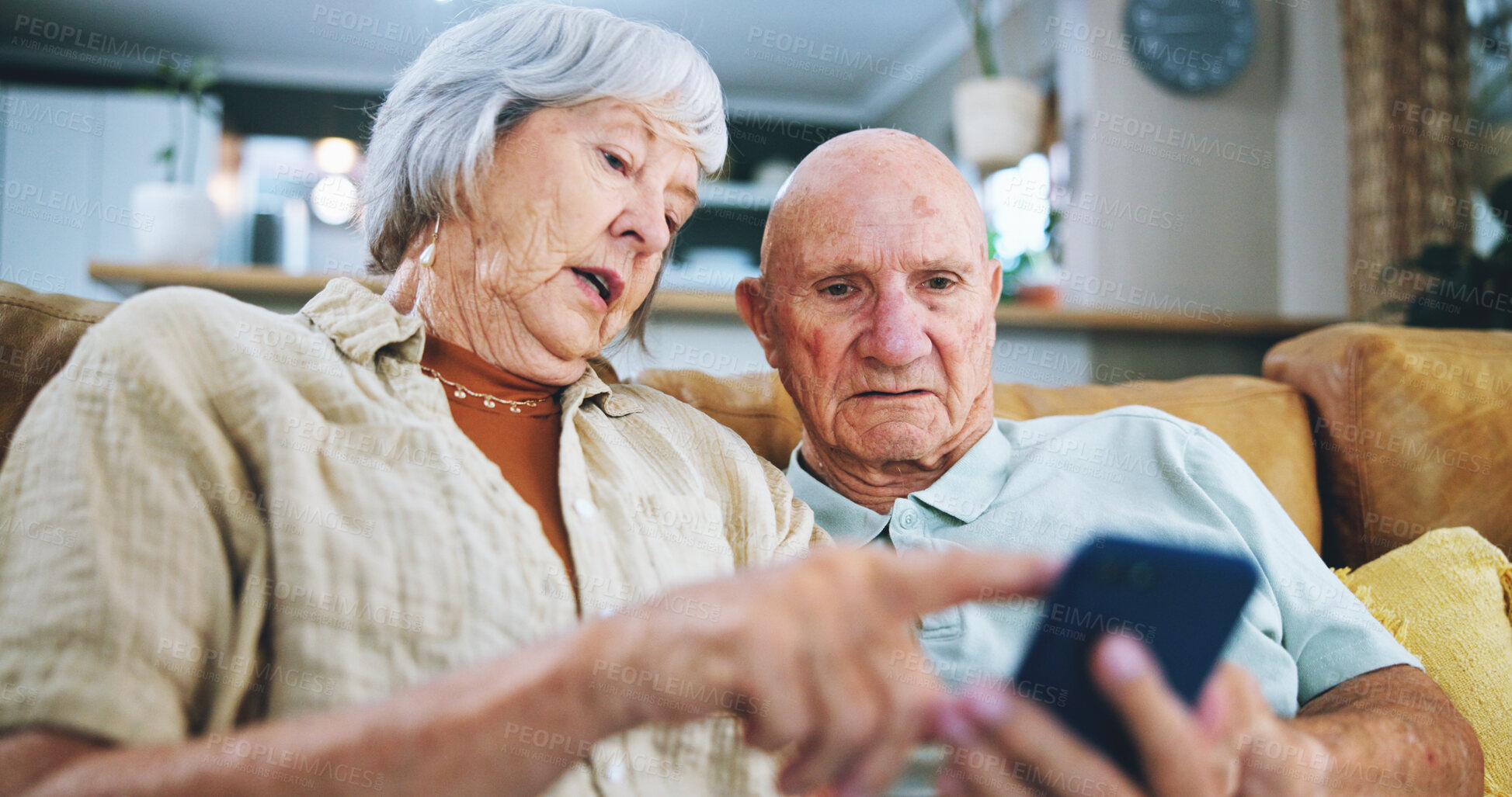 Buy stock photo Senior couple, phone and reading on sofa with point, choice and click with video, download or search in home. Elderly woman, man and smartphone on lounge couch with discussion for social media post