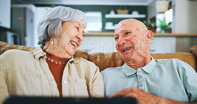 Buy stock photo Senior, happy couple and laughing with tablet for funny movie, entertainment or online streaming on sofa at home. Elderly man and woman with smile for comedy, humor or joke in living room at house