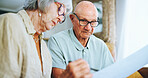 Senior couple, paperwork and reading in home for finance, life insurance and planning for assets. People, documents and application for mortgage loan, speaking and contract for investment policy