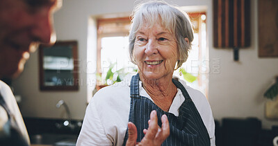 Buy stock photo Senior couple, cooking and happy in kitchen with conversation, help and funny memory in home. Elderly woman, man and talking with meal prep, nutrition and food for wellness in retirement at house