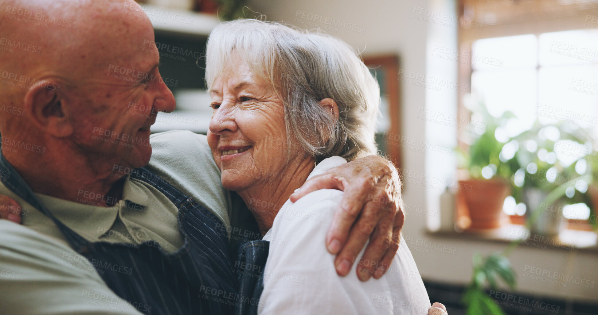 Buy stock photo Senior couple, hug and happy in kitchen with love, support and bonding for health, wellness and nutrition. Elderly man and woman embrace for cooking and marriage at home  for romance or anniversary