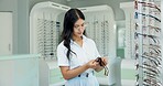 Woman, glasses and cloth at shop for optometry, vision and wellness for eyesight, cleaning and dirt. Person, optician and fabric for dust with inspection for eye care, health or style at retail store