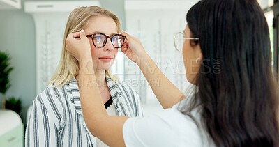 Buy stock photo Vision, optometrist and help customer with glasses for eye health, wellness or care. Ophthalmology, lens frame and woman fitting client for choice of spectacles or eyesight correction at retail store