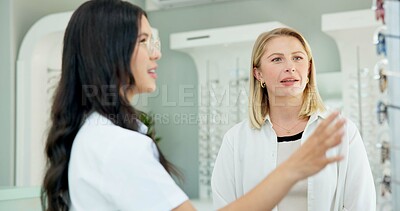 Buy stock photo Choice, optometrist and help customer with glasses for eye health, wellness or care of doctor. Ophthalmology, lens frame and woman assist client for advice, spectacles or eyesight correction at store