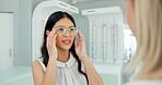 Woman, optometrist and consultation with glasses in store with choice, help and eye care for vision. People, optician and customer with smile for health, wellness or decision for trendy style in shop