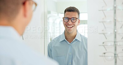 Buy stock photo Man, glasses and mirror at store for eye care, vision and wellness for eyesight, smile and choice. Person, customer and check reflection with decision for optometry, happy and style at retail shop