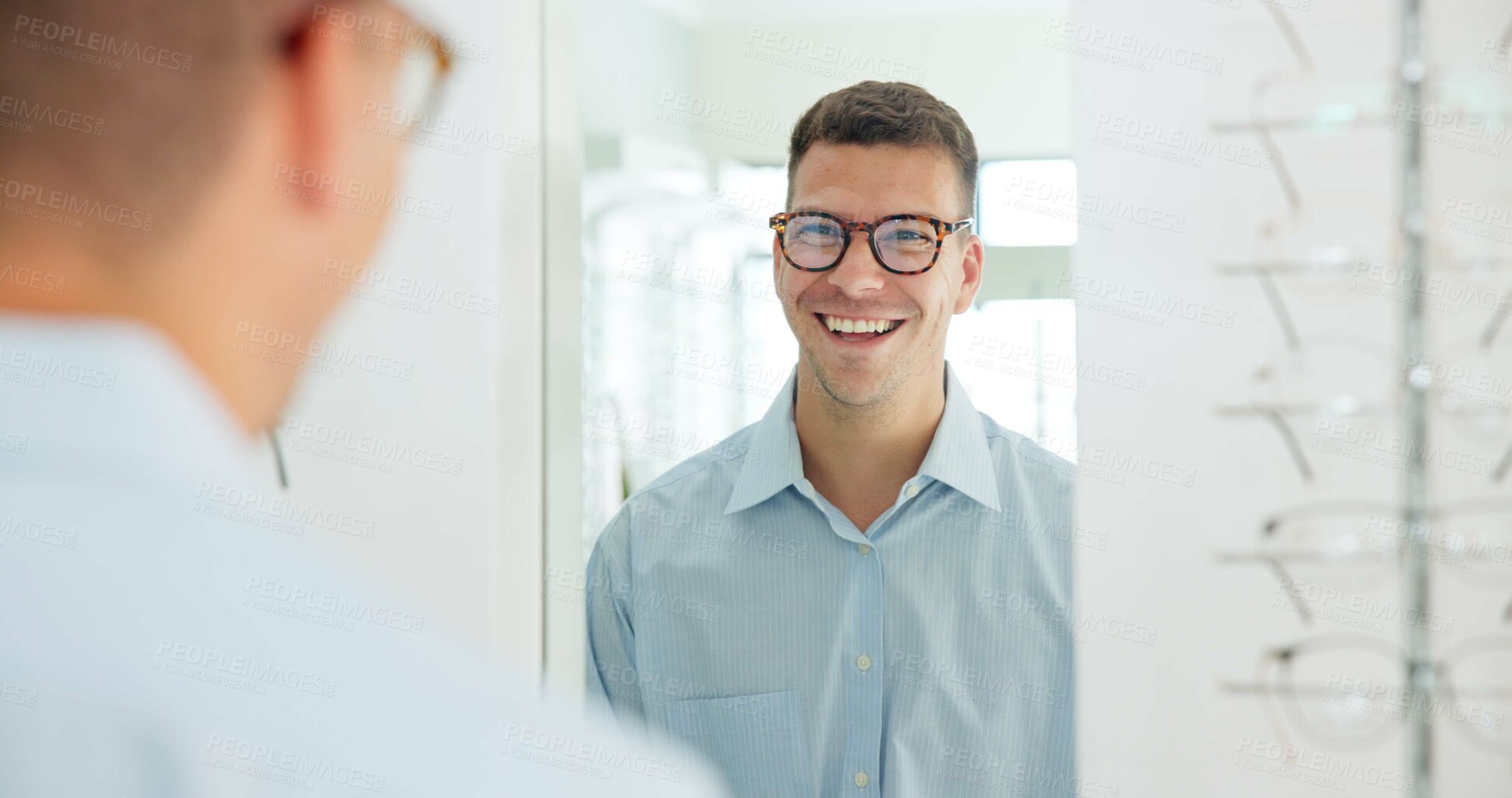 Buy stock photo Man, glasses and mirror at store for eye care, vision and wellness for eyesight, smile and choice. Person, customer and check reflection with decision for optometry, happy and style at retail shop