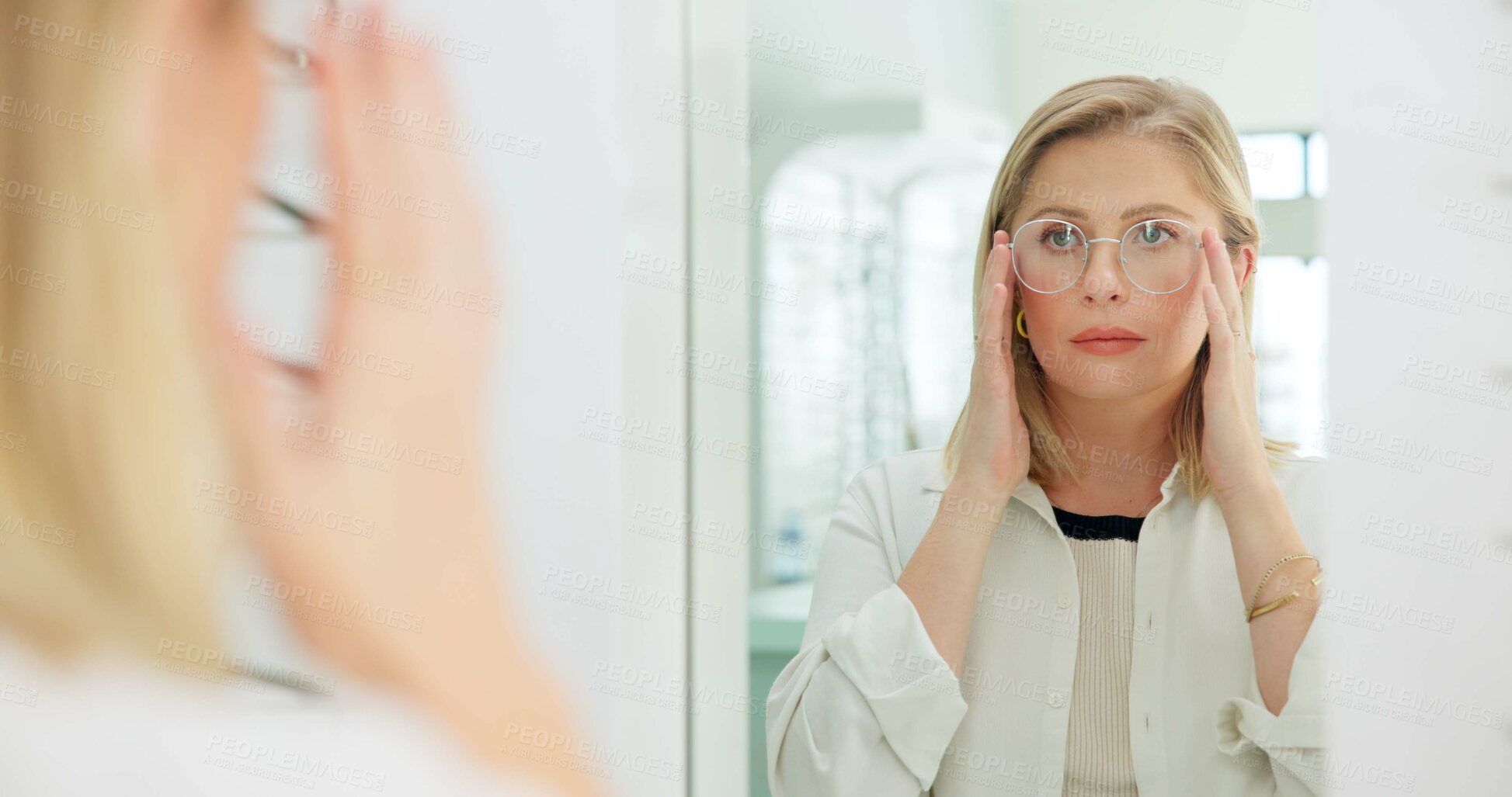 Buy stock photo Woman, glasses and mirror at store for vision, eye care and wellness for eyesight, frame and choice. Person, customer and check reflection with decision for optometry, health and style at retail shop