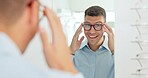 Man, glasses and mirror at store for optometry, vision or wellness for eyesight, smile and choice. Person, customer and check reflection with decision for eye health, happy and style at retail shop