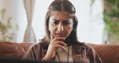 Buy stock photo Thinking, woman and laptop on sofa for confused, concerned or internet browsing in home. Female person, thoughtful or deep frown with technology on couch for streaming news or reading blog post