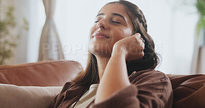 Buy stock photo Sleeping, woman and relax on sofa house listening to music with wireless earphones, radio and podcast in living room. Smile, female person and streaming audio, connection and subscription for peace